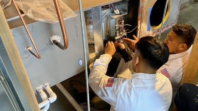 Two techs setting up a heating unit.