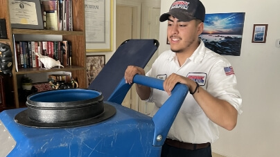 A tech pushing a large water unit.